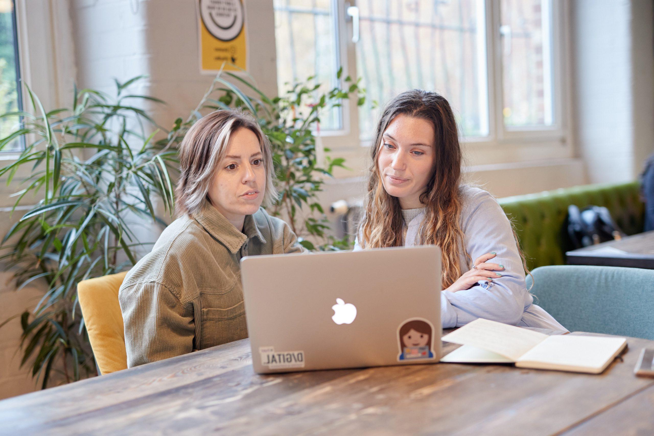 Two women looking at a laptop